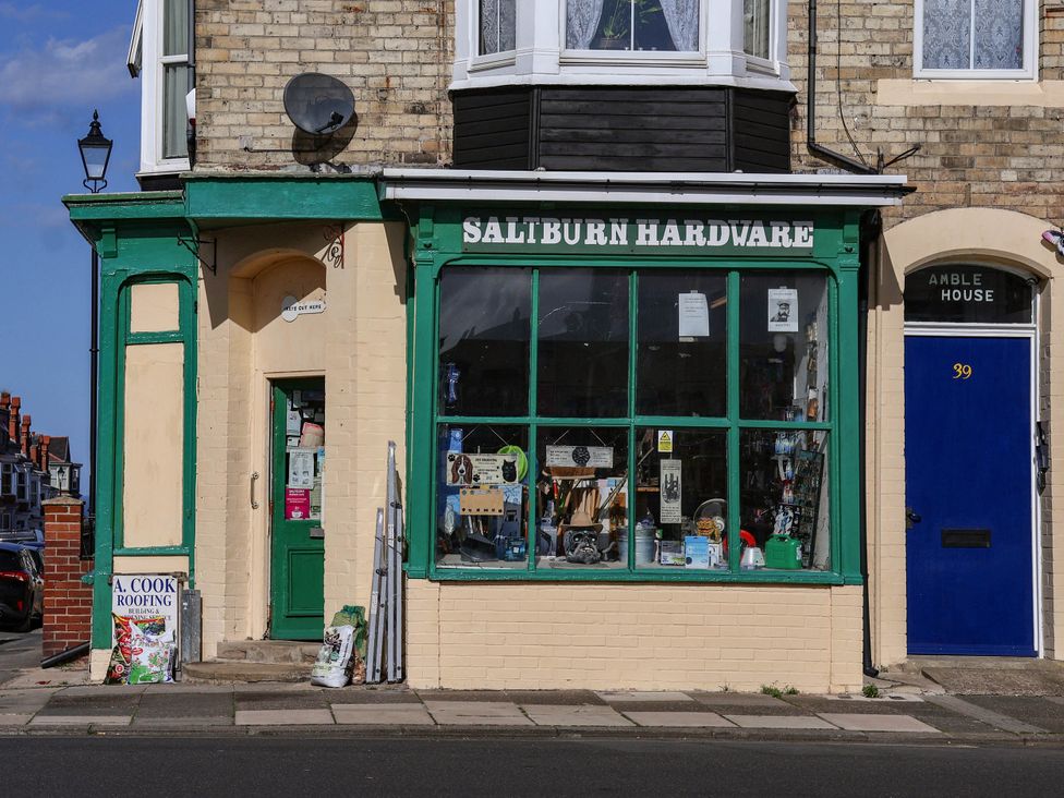 A hardware store front with window display and door at Cowslip in Saltburn-By-The-Sea