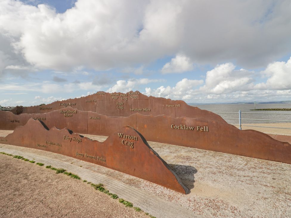 A sculpture depicting mountain names by the coastline at Cockle Bay Cottage in Heysham
