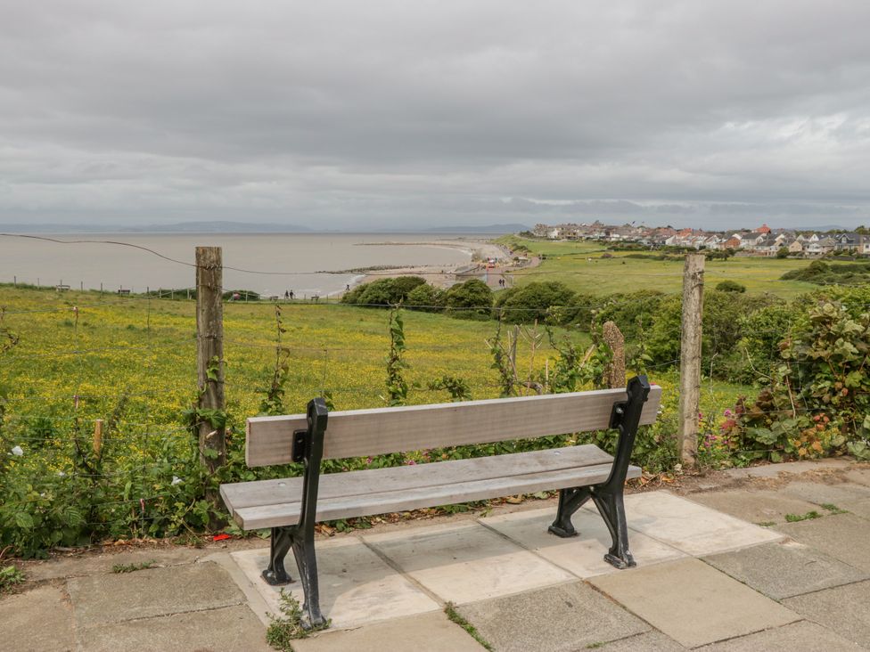 A view of a bench overlooking the sea at Cockle Bay Cottage in Heysham