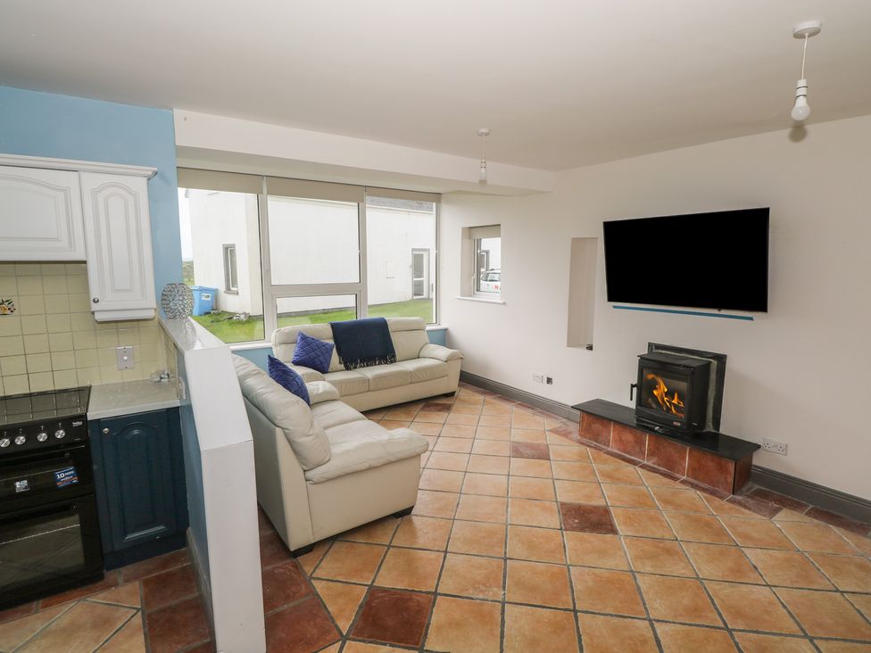 A living room with a couch and fireplace at No.5 Beach Cottages in Keel, County Mayo