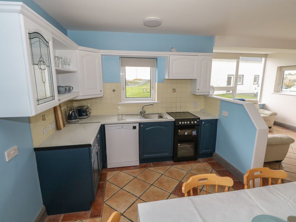 A kitchen with cabinets and appliances at No.5 Beach Cottages Keel, County Mayo