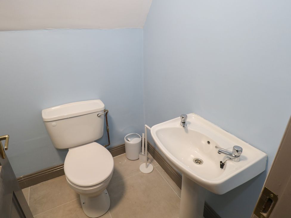 A bathroom with a toilet and sink at No.5 Beach Cottages, Keel, County Mayo