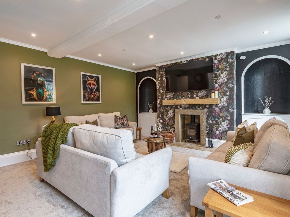 A living room with a sofa and television at Snowdonia Manor in Dolgellau