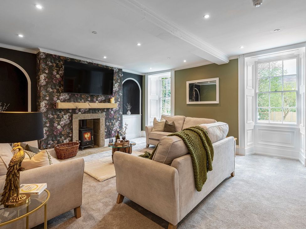 A living room with a fireplace and a television at Snowdonia Manor in Dolgellau