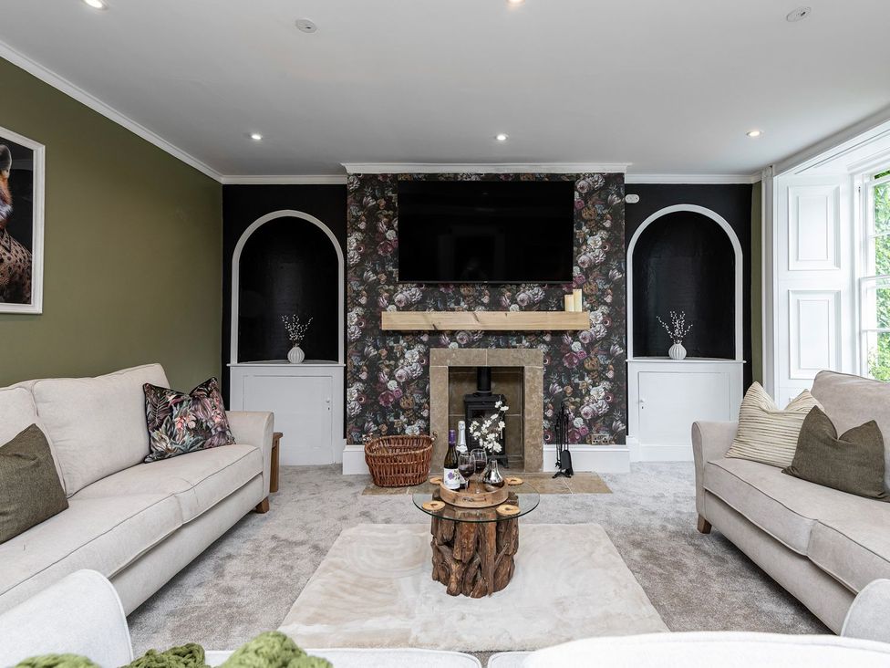 A living room with a sofa and coffee table at Snowdonia Manor in Dolgellau