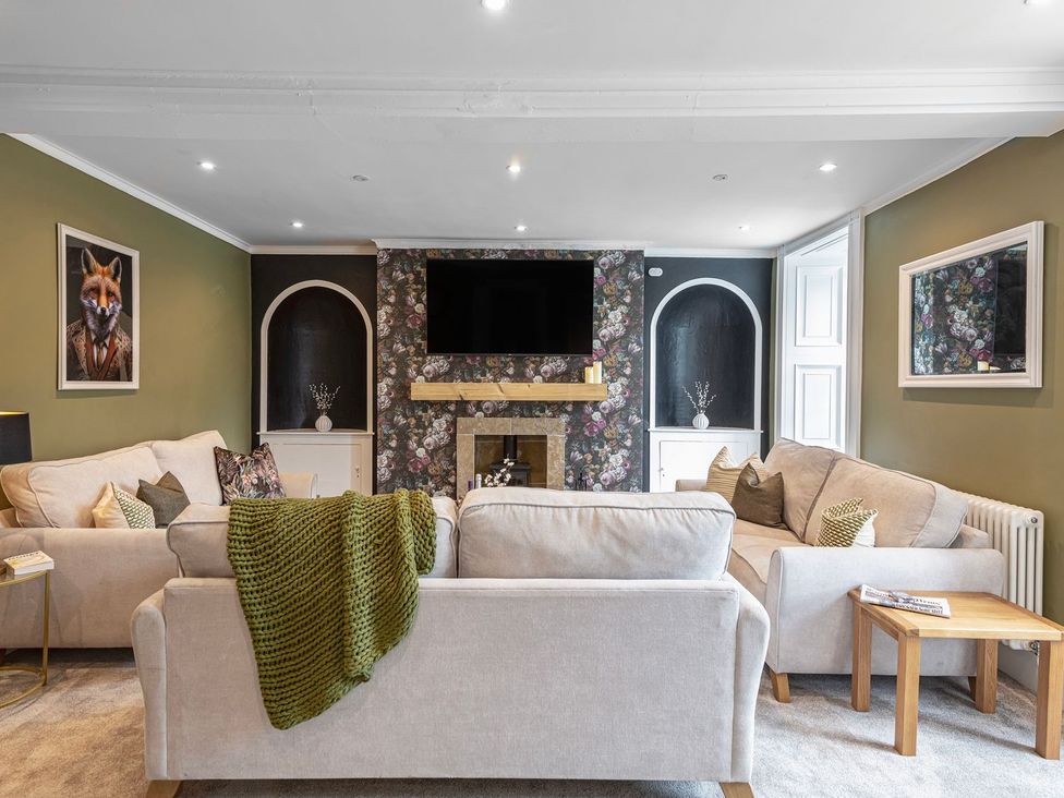 A living room with a sofa and coffee table at Snowdonia Manor in Dolgellau