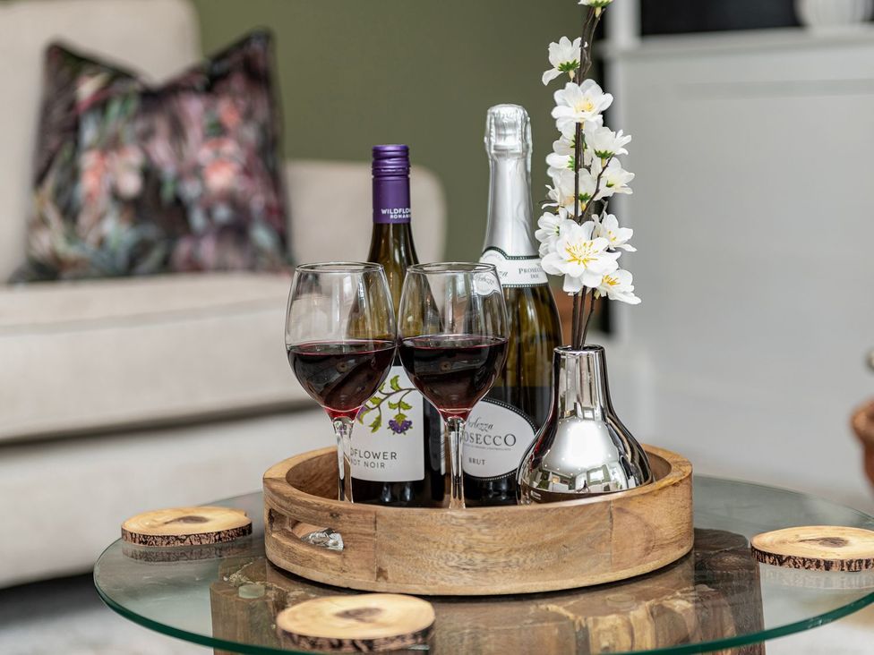 A living room with wine glasses and a flower vase at Snowdonia Manor in Dolgellau