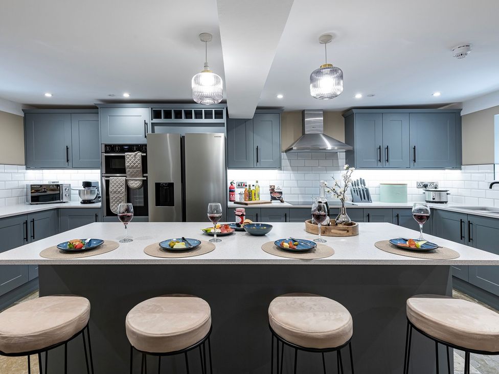 A kitchen with a large island and appliances at Snowdonia Manor in Dolgellau