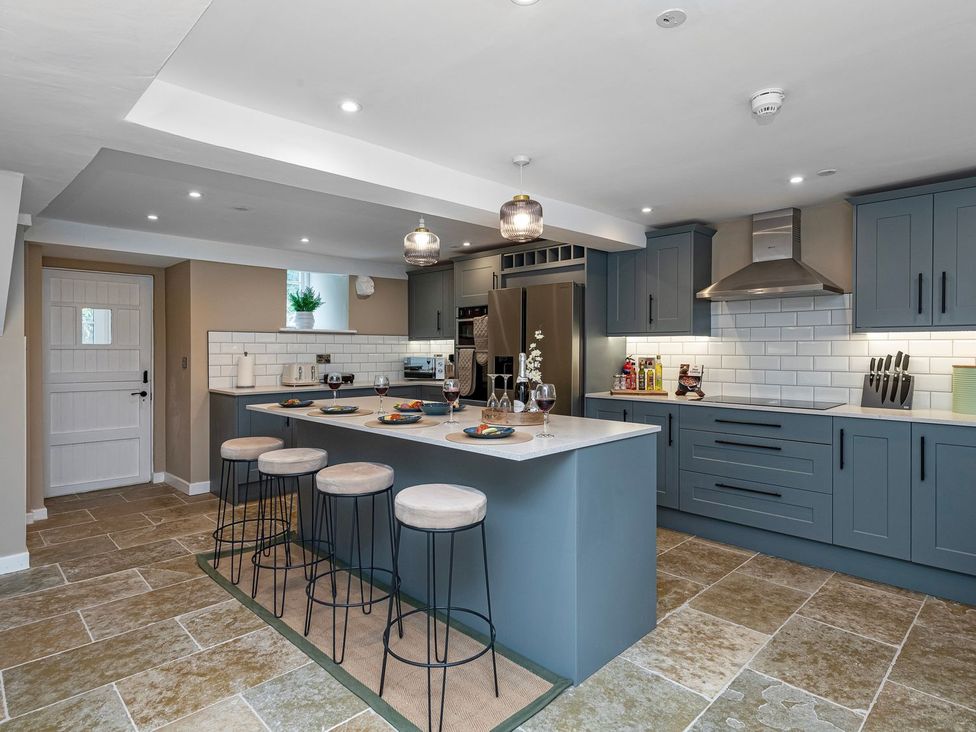 A kitchen with cabinets and a bar area at Snowdonia Manor in Dolgellau
