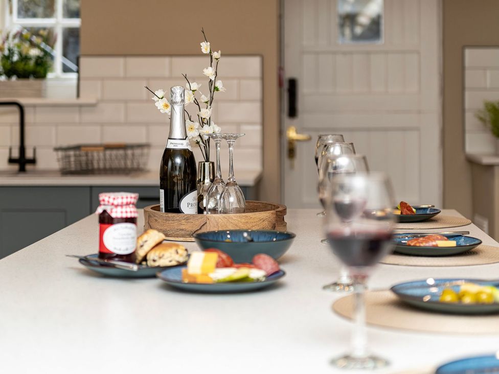 A kitchen with drinks and snacks on the table at Snowdonia Manor in Dolgellau