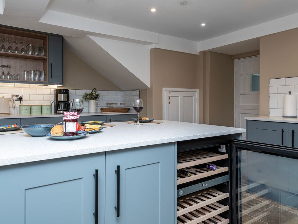 A kitchen with wine glasses and food on a countertop at Snowdonia Manor in Dolgellau