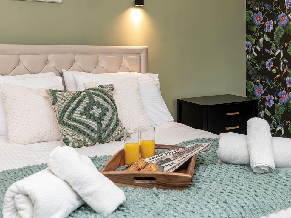A bedroom with a bed and breakfast items at Snowdonia Manor in Dolgellau