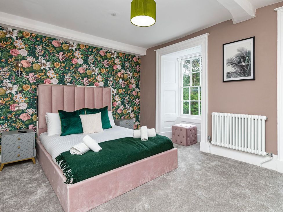 A bedroom with a bed and window at Snowdonia Manor in Dolgellau