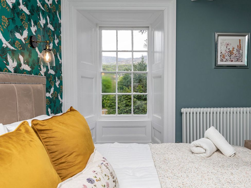 A bedroom with a bed and window at Snowdonia Manor in Dolgellau