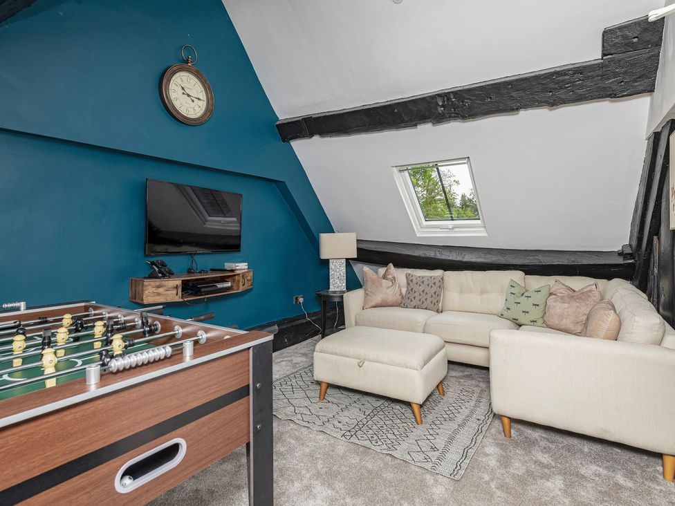 A snug with a foosball table and a sofa at Snowdonia Manor in Dolgellau