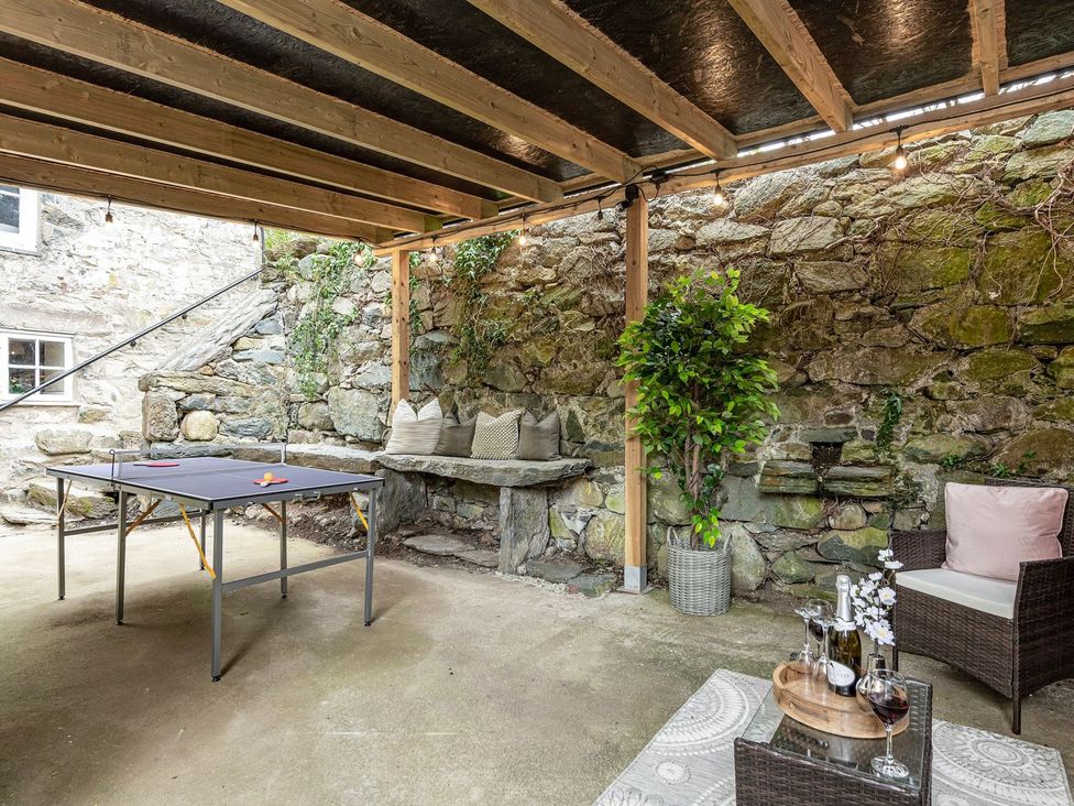 An outdoor seating area with a table and bench at Snowdonia Manor in Dolgellau