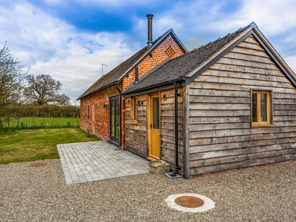 An exterior view of a house with a patio at Johnsons Smallholding in Market Drayton