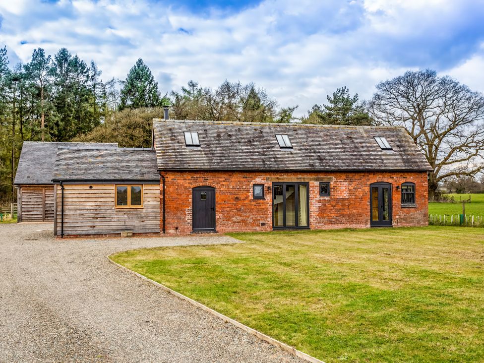 An exterior view of a house with a lawn at Johnsons Smallholding in Market Drayton