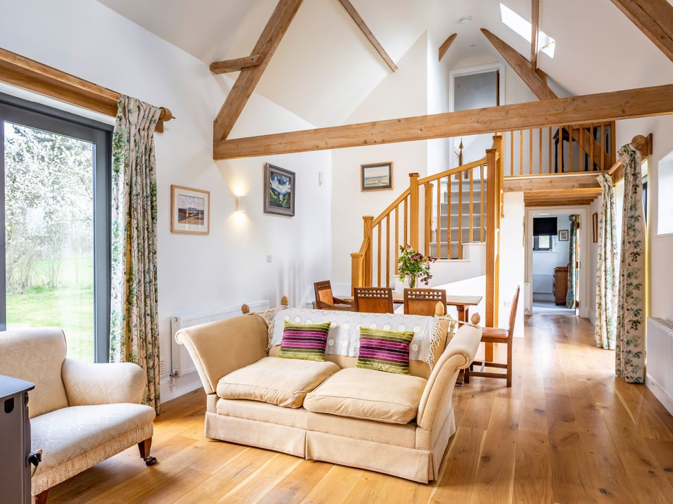 A living room with a sofa and armchair at Johnsons Smallholding in Market Drayton