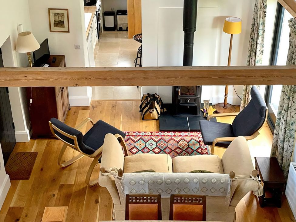 A living room with a sofa and armchairs at Johnsons Smallholding in Market Drayton