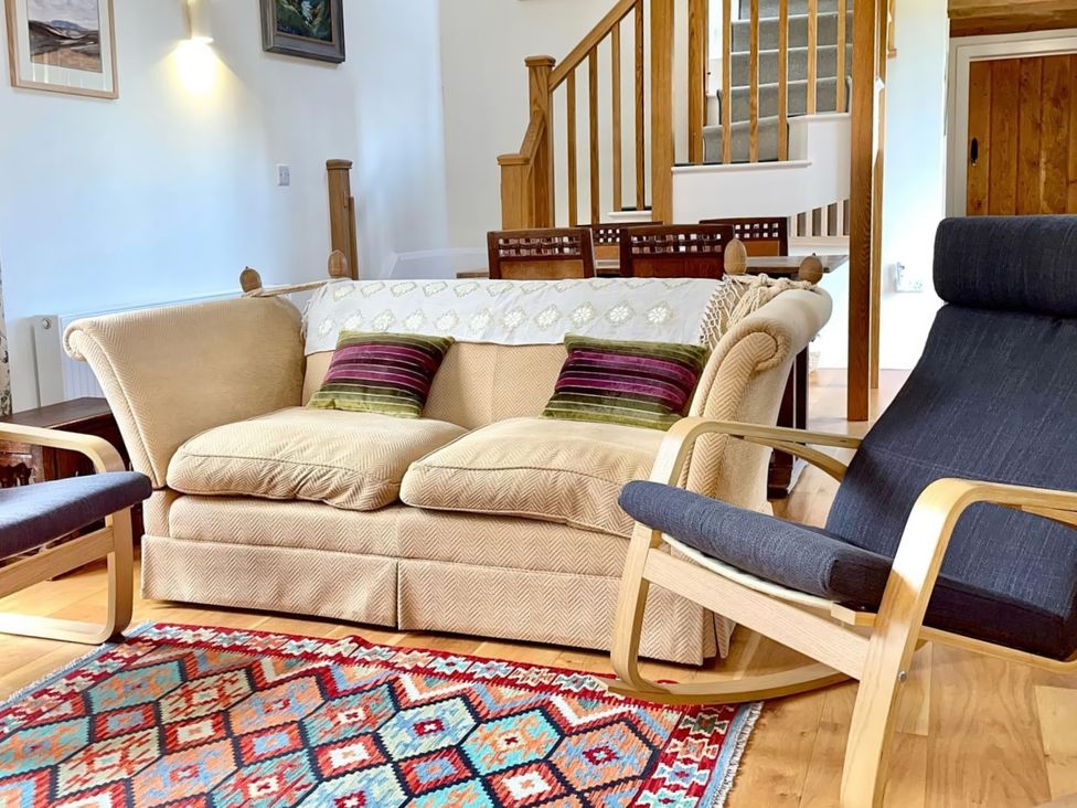 A living room with a sofa and rocking chair at Johnsons Smallholding Market Drayton