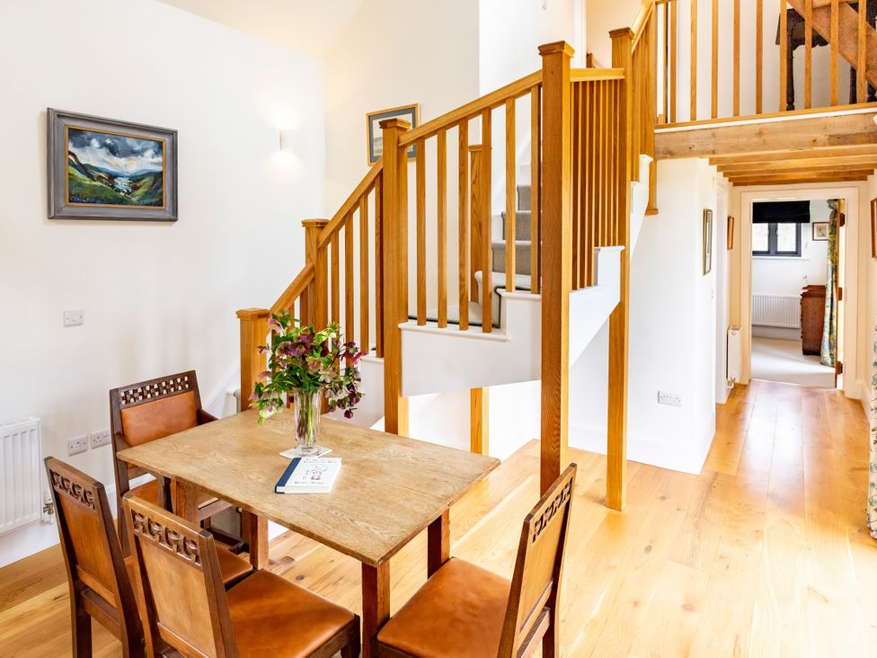 A dining room with a table and chairs at Johnsons Smallholding in Market Drayton