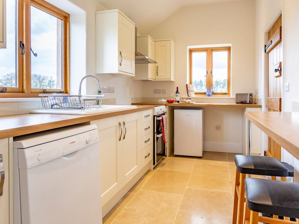 A kitchen with a sink and dishwasher at Johnsons Smallholding Market Drayton