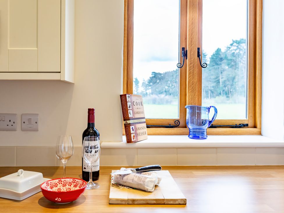 A kitchen with wine and glass on a counter at Johnsons Smallholding in Market Drayton