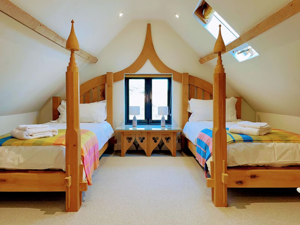 A bedroom with two beds and a window at Johnsons Smallholding in Market Drayton