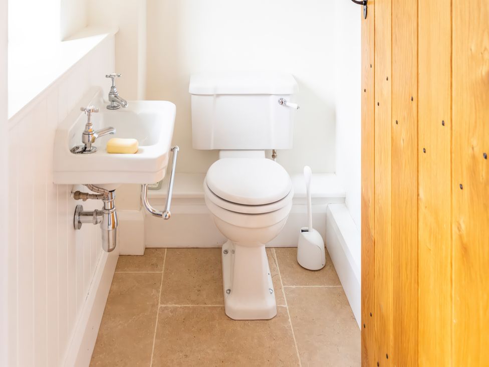 A bathroom with a toilet and sink at Johnsons Smallholding Market Drayton