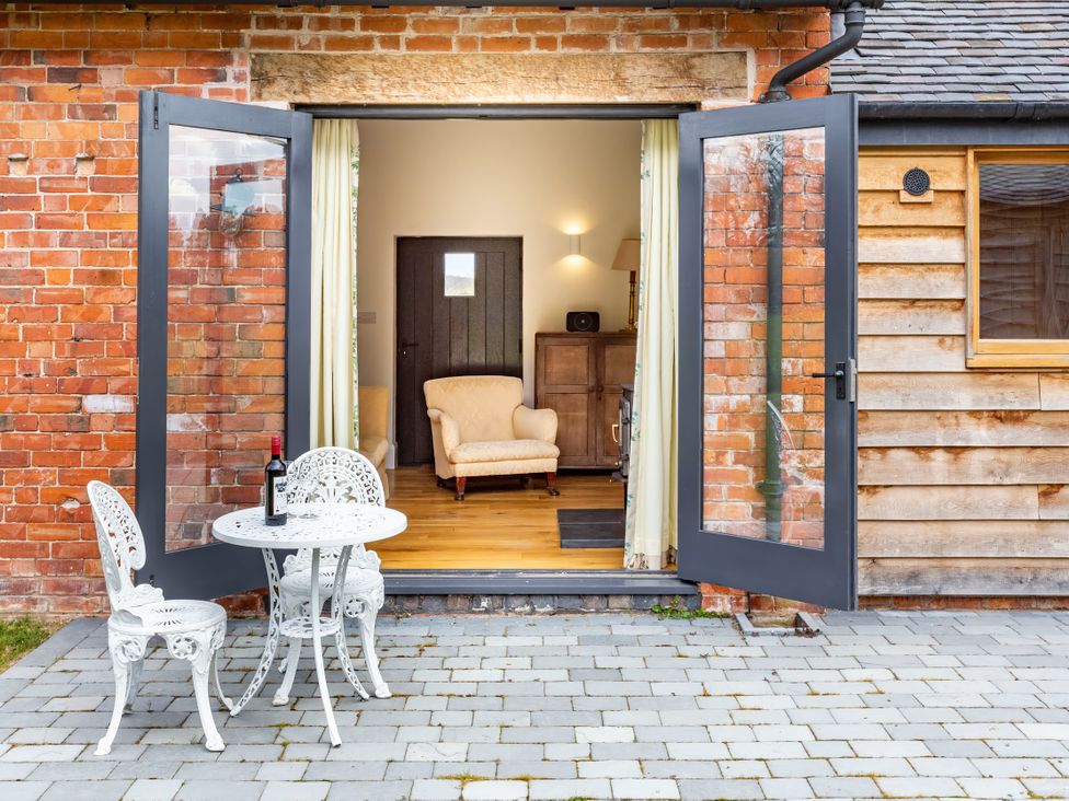 An outdoor seating area with a table and chairs at Johnsons Smallholding in Market Drayton