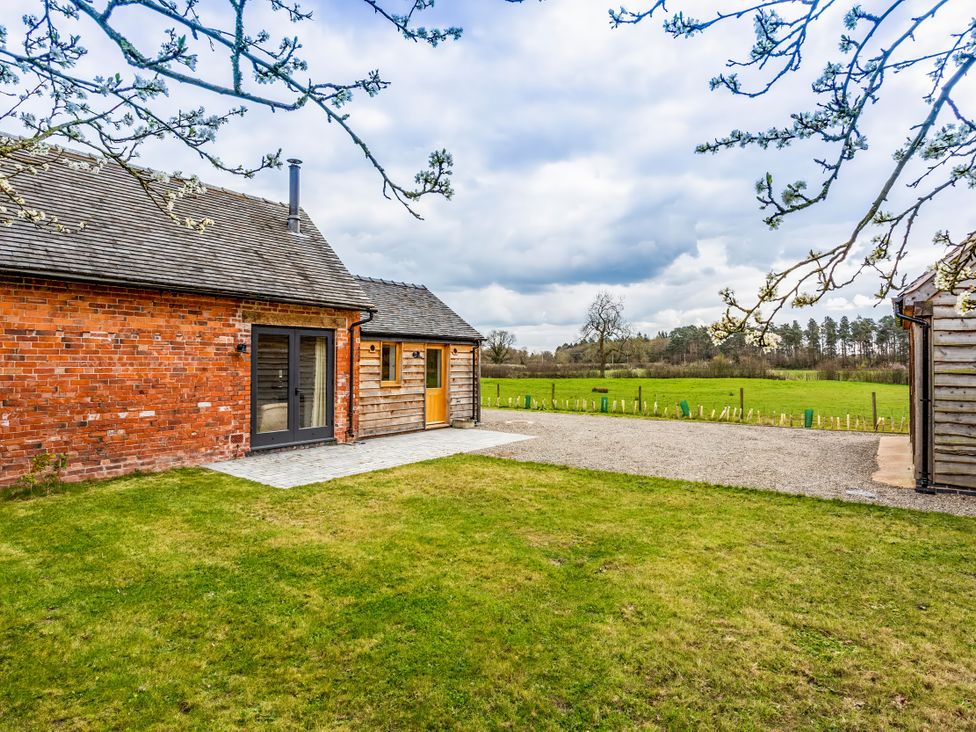 An outdoor area with a building and grass at Johnsons Smallholding in Market Drayton