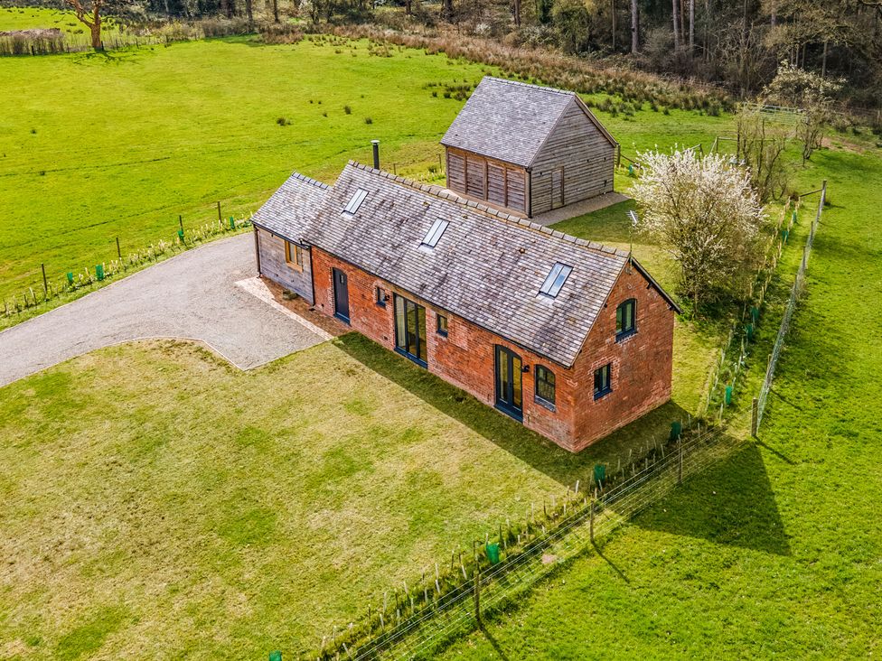 A house and shed situated in a grassy area at Johnsons Smallholding in Market Drayton