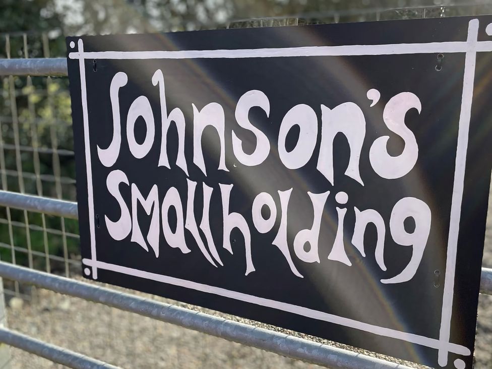 A sign that reads Johnson's Smallholding at Johnsons Smallholding in Market Drayton
