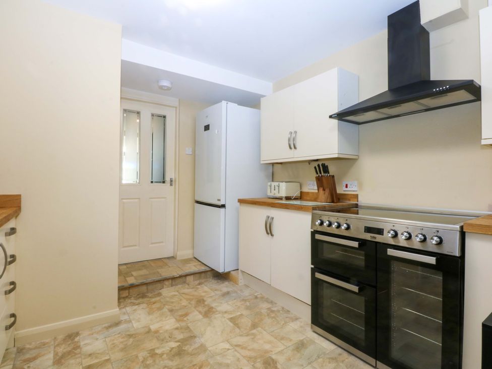 A kitchen with a refrigerator and oven at Curzon Heights in Llandudno