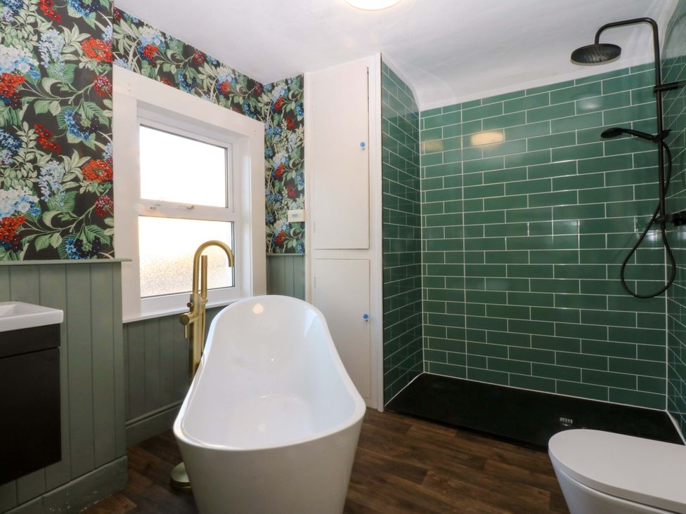 A bathroom with shower and bathtub at Curzon Heights in Llandudno