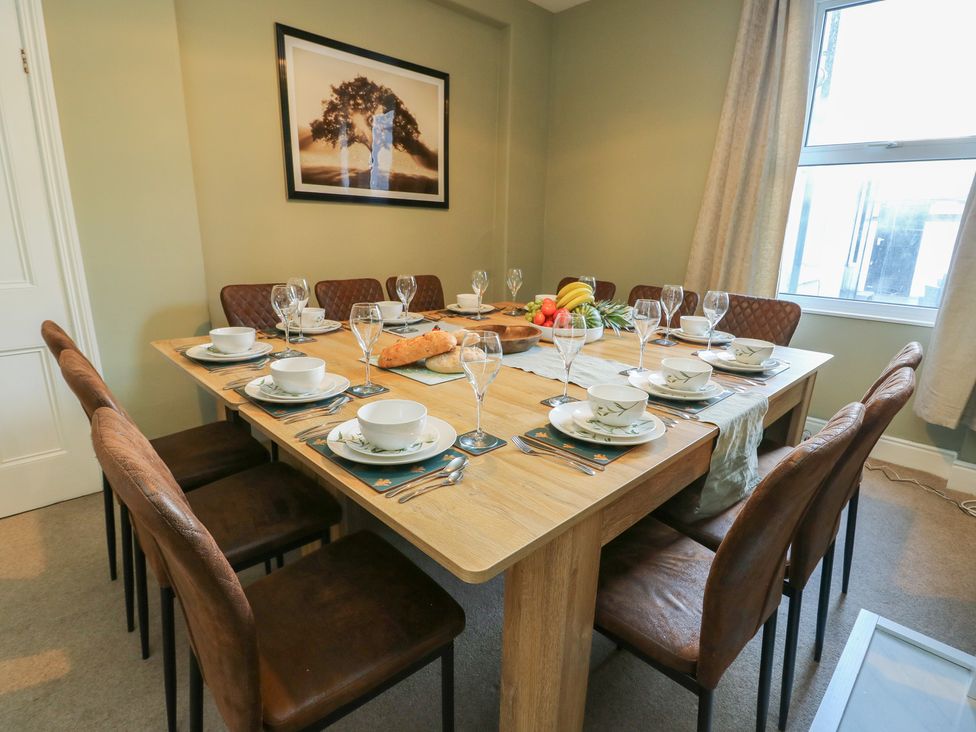 A dining room with a table set for dinner at Curzon Heights in Llandudno