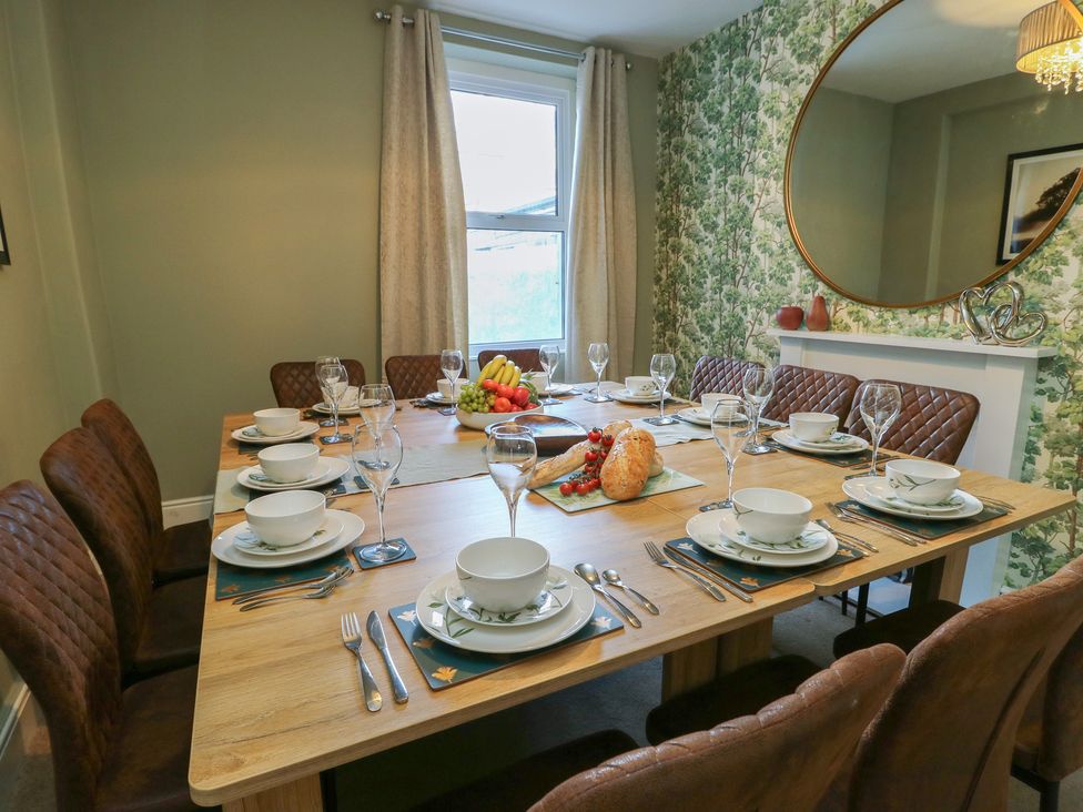 A dining room with a table and chairs at Curzon Heights in Llandudno