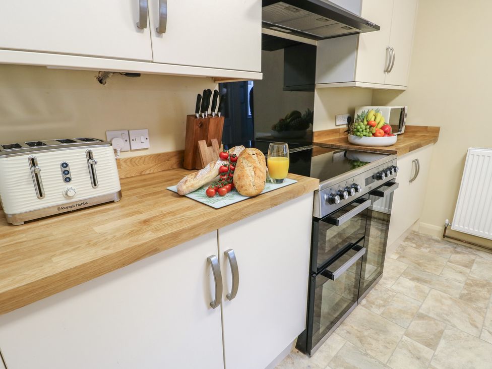 A kitchen with a toaster and oven at Curzon Heights in Llandudno