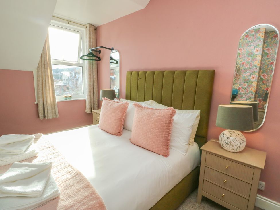 A bedroom with a bed and bedside table at Curzon Heights in Llandudno