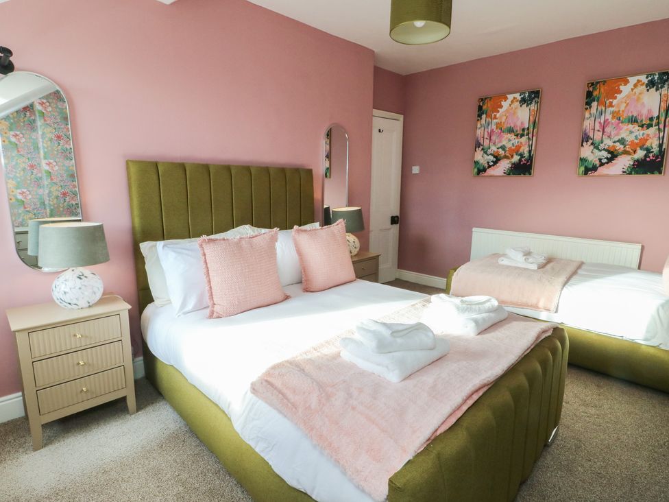 A bedroom with a bed and nightstand at Curzon Heights in Llandudno
