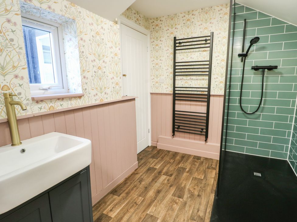 A bathroom with a sink and shower at Curzon Heights in Llandudno