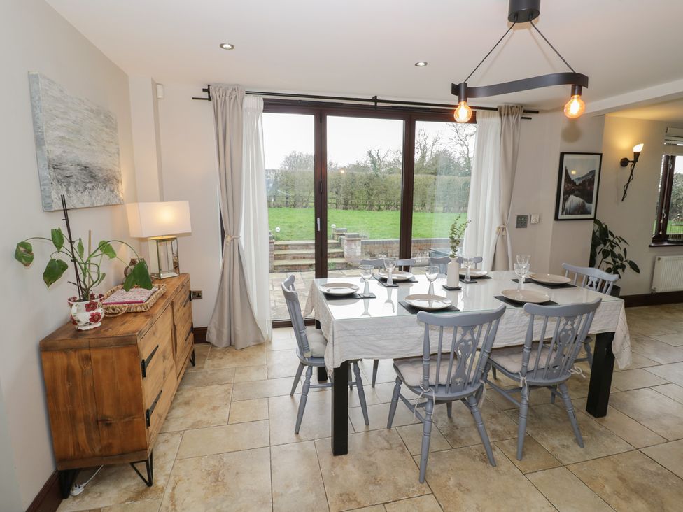 A dining room with a table and chairs at Little Acre, Church Lench near Harvington