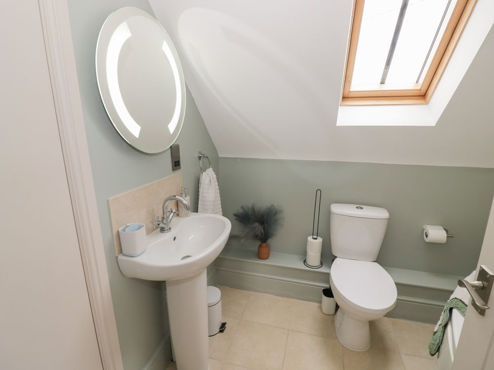 A bathroom with a sink and toilet at Little Acre in Church Lench near Harvington