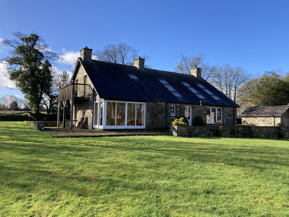 A house with a balcony and windows at Bryn Isaf in Ystrad Meurig