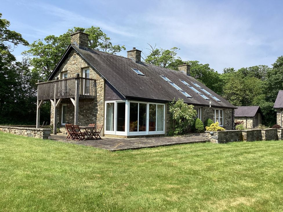 A house with balcony and patio furniture at Bryn Isaf in Ystrad Meurig