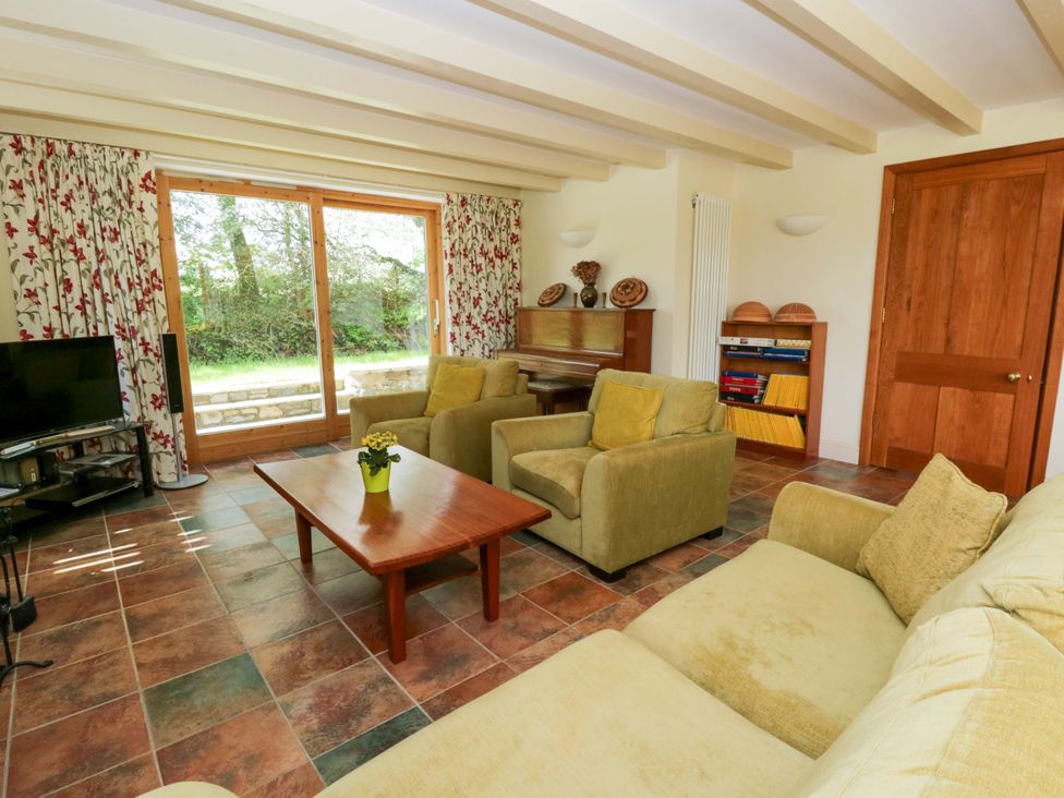 A living room with furniture including a sofa and television at Bryn Isaf in Swyddffynnon near Pontrhydfendigaid