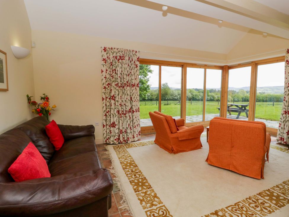 A snug with a sofa and armchairs at Bryn Isaf in Swyddffynnon near Pontrhydfendigaid