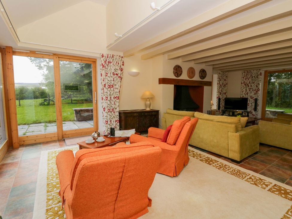 A living room with sofas and a coffee table at Bryn Isaf in Swyddffynnon near Pontrhydfendigaid