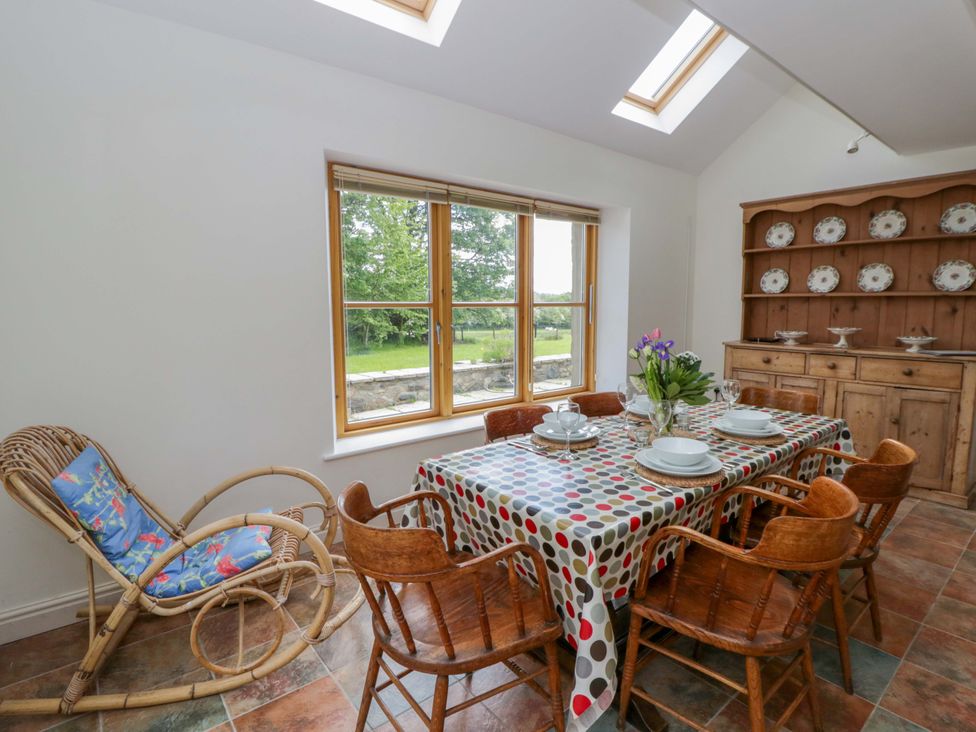 A dining room with a table and chairs at Bryn Isaf in Swyddffynnon near Pontrhydfendigaid